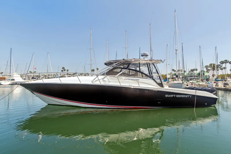 Swift Serenity Yacht Photos Pics 2008 Fountain 38 Sport Cruiser boat docked in marina, clear sky background.