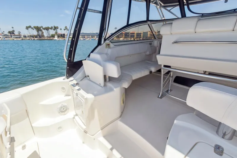 Swift Serenity Yacht Photos Pics 2008 Fountain 38 Sport Cruiser interior with white seating, docked by calm waters.