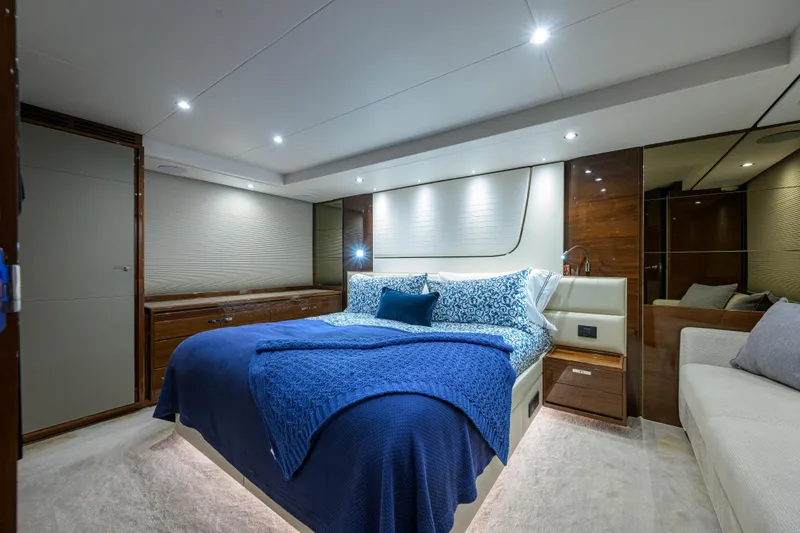 Miss Amy Yacht Photos Pics Luxurious bedroom interior of 2020 Princess F70 yacht with elegant blue bedding.