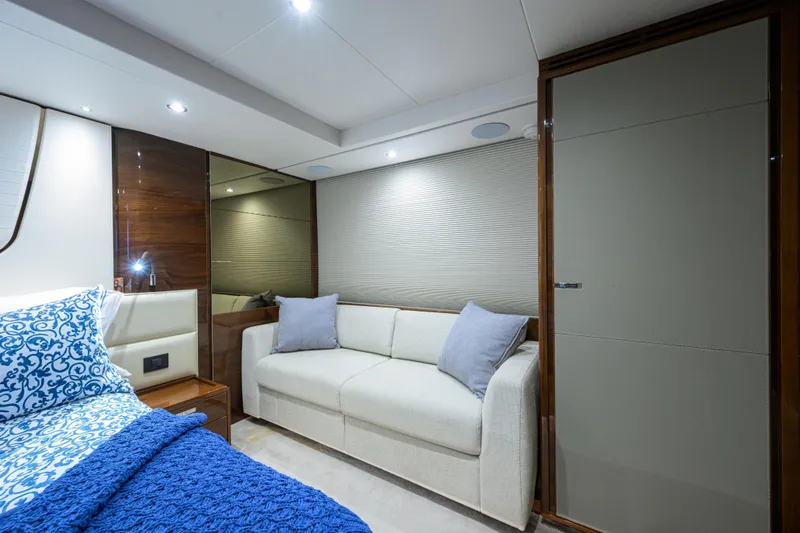 Miss Amy Yacht Photos Pics Luxurious interior of 2020 Princess F70 yacht with elegant bedding and cozy seating.