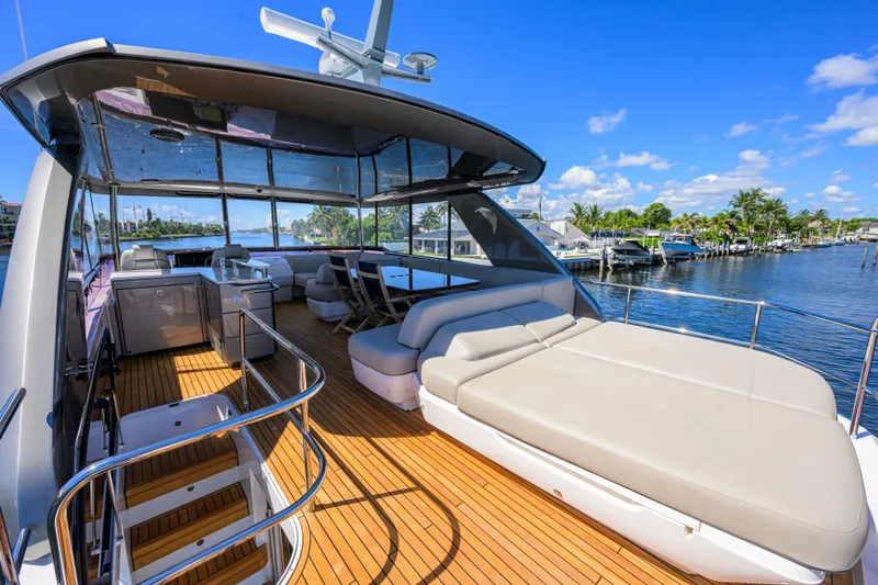 Miss Amy Yacht Photos Pics Luxurious 2020 Princess F70 yacht deck with seating, overlooking serene waterfront.