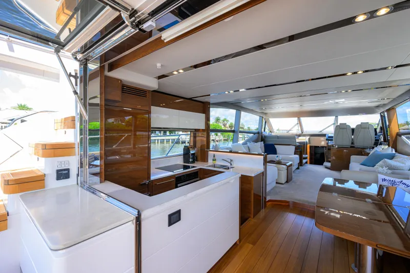 Miss Amy Yacht Photos Pics Luxurious interior of 2020 Princess F70 yacht with modern kitchen and spacious seating area.
