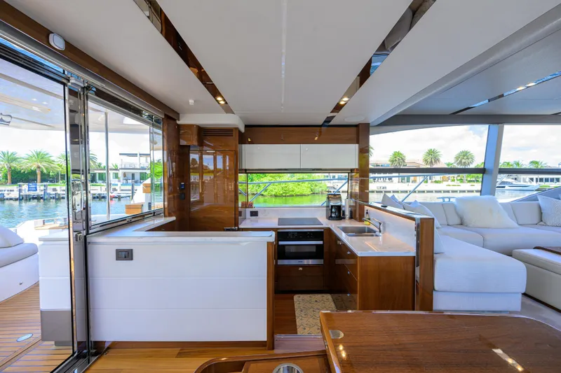 Miss Amy Yacht Photos Pics Luxurious interior of 2020 Princess F70 yacht with modern kitchen and scenic water view.