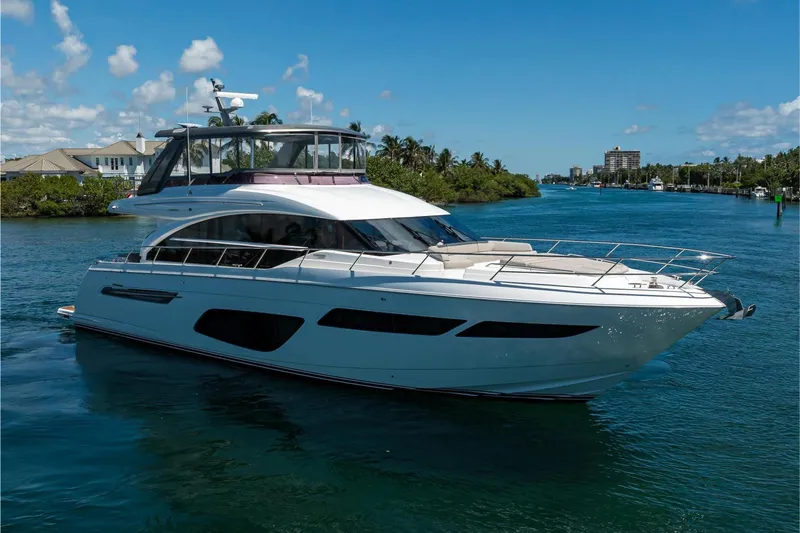 Miss Amy Yacht Photos Pics Luxurious 2020 Princess F70 yacht cruising on a sunny day in a scenic waterway.