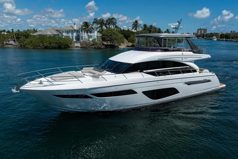 Miss Amy Yacht Photos Pics Luxurious 2020 Princess F70 yacht cruising on a sunny day near waterfront homes.
