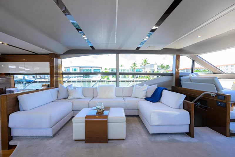 Miss Amy Yacht Photos Pics Luxurious interior of 2020 Princess F70 yacht with elegant white seating and waterfront view.