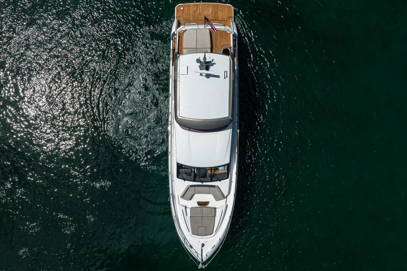 Miss Amy Yacht Photos Pics Aerial view of 2020 Princess F70 yacht cruising on clear water.