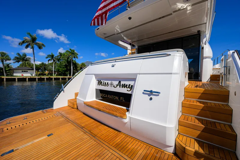 Miss Amy Yacht Photos Pics Luxury 2020 Princess F70 yacht docked in Boca Raton, Florida, with wooden deck and stairs.