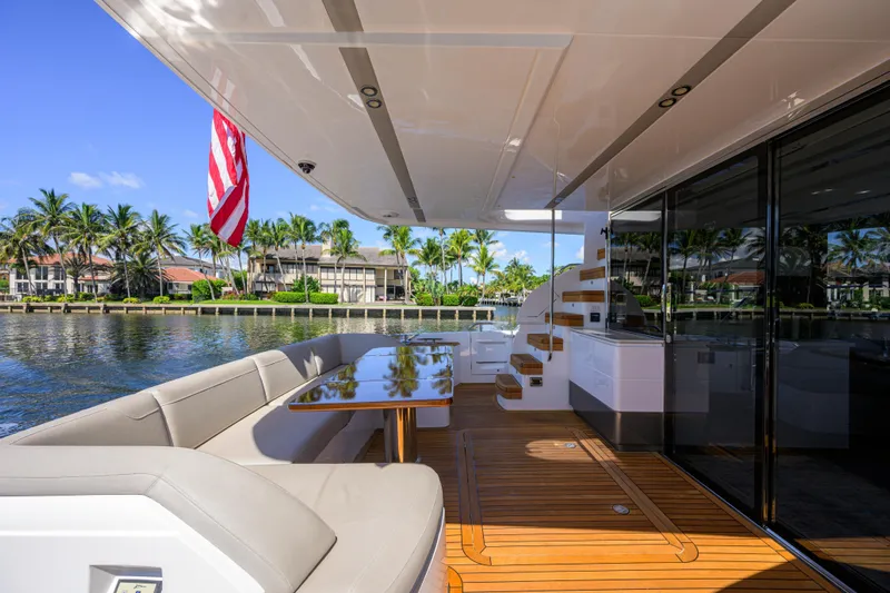Miss Amy Yacht Photos Pics Luxurious 2020 Princess F70 yacht deck with elegant seating and scenic waterfront view.