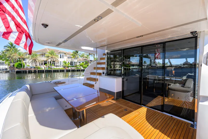 Miss Amy Yacht Photos Pics Luxurious 2020 Princess F70 yacht deck with seating, table, and waterfront view.