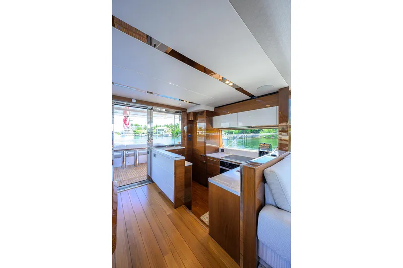 Miss Amy Yacht Photos Pics Luxurious interior of 2020 Princess F70 yacht with modern kitchen and wooden flooring.