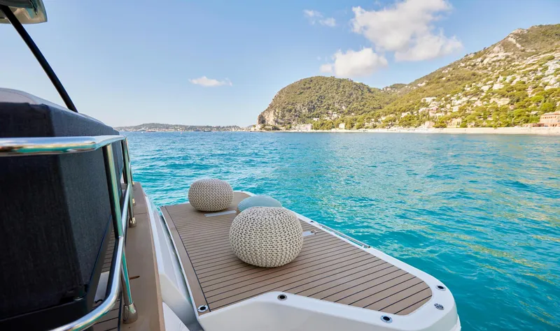  Yacht Photos Pics Prestige M48 yacht 2025 model, scenic ocean view with mountains in the background.