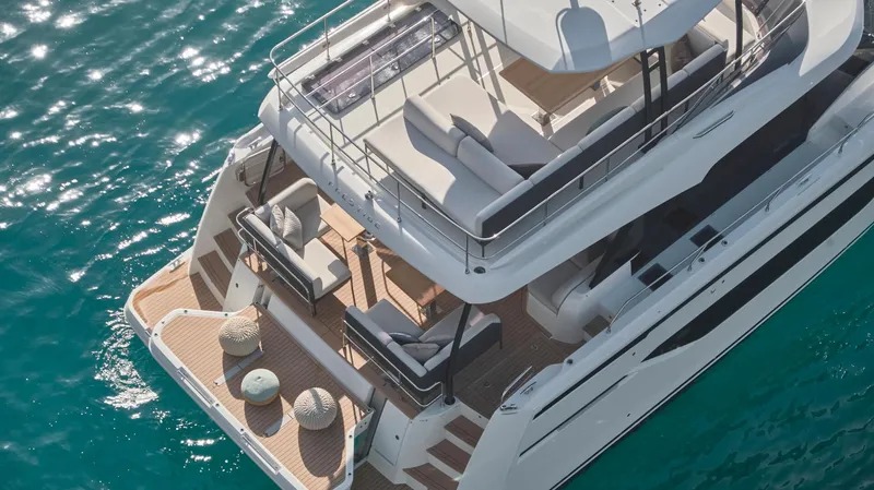  Yacht Photos Pics Prestige M48 2025 luxury yacht on turquoise water, aerial view.