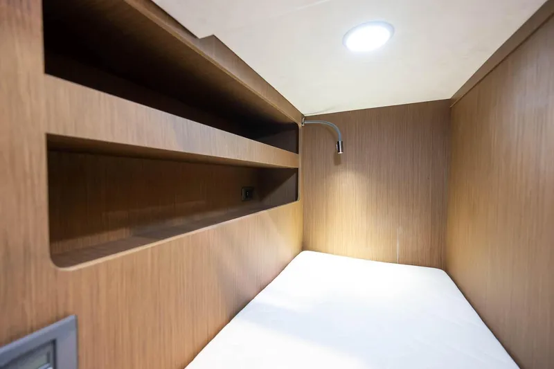  Yacht Photos Pics Compact cabin interior of Prestige M48 2025 model with wooden shelves and modern lighting.