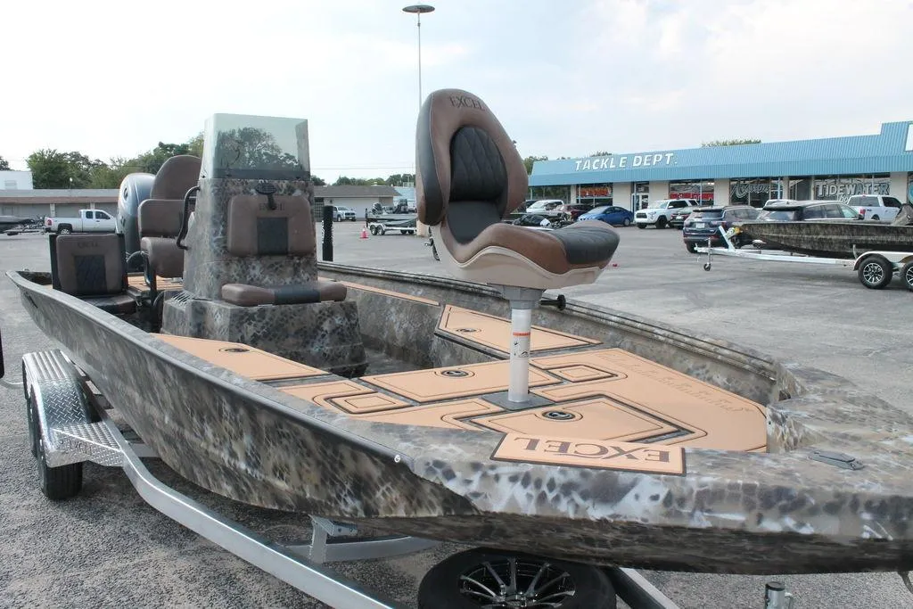 2026 Excel Bay Pro Elite 203 boat displayed at dealership, featuring camo design and elevated seating.