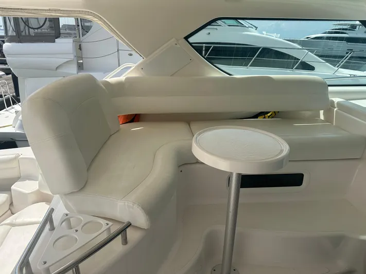 Selladoor (previously "czech Mate") Yacht Photos Pics 2007 Tiara Yachts 4300 Sovran interior with white seating and small table.
