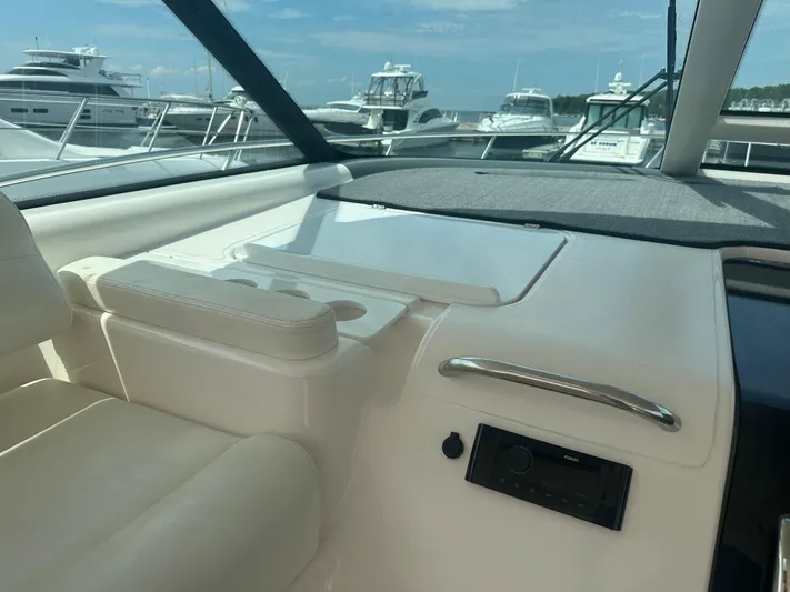 Selladoor (previously "czech Mate") Yacht Photos Pics Interior view of 2007 Tiara Yachts 4300 Sovran, showcasing helm and dashboard with marina background.