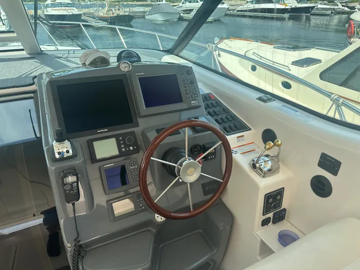 Selladoor (previously "czech Mate") Yacht Photos Pics 2007 Tiara Yachts 4300 Sovran helm with navigation equipment and wooden steering wheel.