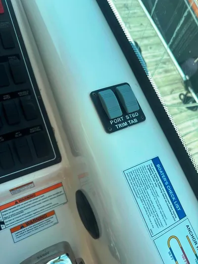 Selladoor (previously "czech Mate") Yacht Photos Pics 2007 Tiara Yachts 4300 Sovran helm controls with trim tab switches and safety checklists.