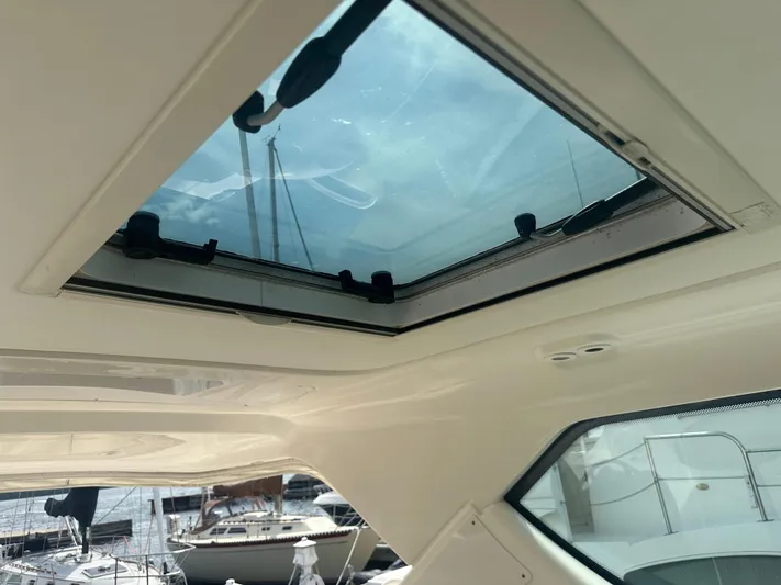 Selladoor (previously "czech Mate") Yacht Photos Pics 2007 Tiara Yachts 4300 Sovran interior with open sunroof and marina view.