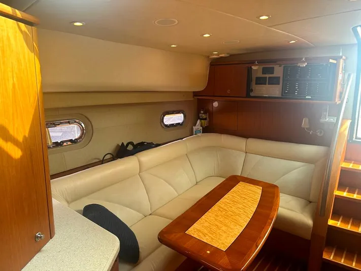 Selladoor (previously "czech Mate") Yacht Photos Pics 2007 Tiara Yachts 4300 Sovran interior with beige seating and wooden table.