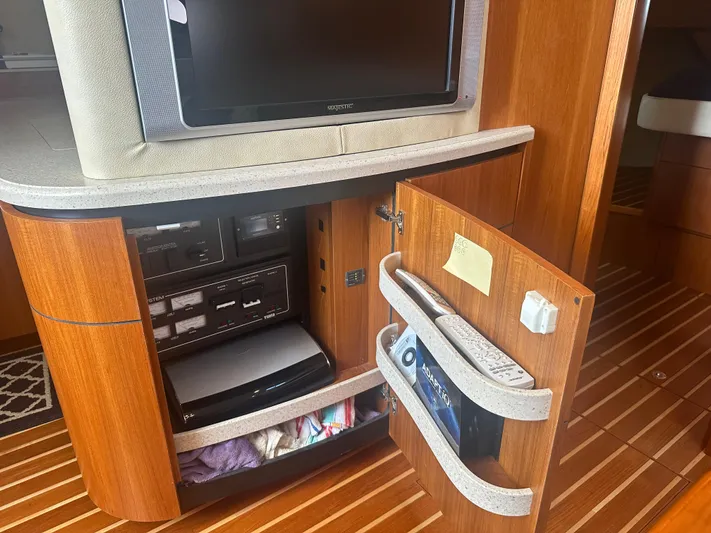 Selladoor (previously "czech Mate") Yacht Photos Pics 2007 Tiara Yachts 4300 Sovran interior with TV, wooden cabinetry, and storage compartments.