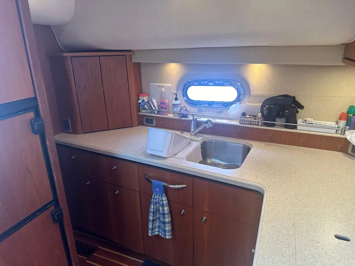 Selladoor (previously "czech Mate") Yacht Photos Pics 2007 Tiara Yachts 4300 Sovran kitchen with wooden cabinets and countertop.