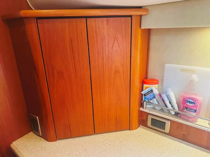 Selladoor (previously "czech Mate") Yacht Photos Pics 2007 Tiara Yachts 4300 Sovran interior cabinet with toiletries and cleaning supplies.