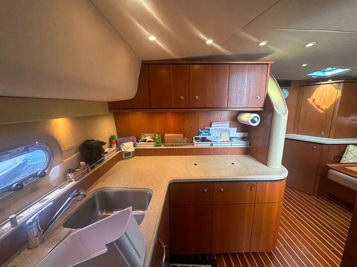Selladoor (previously "czech Mate") Yacht Photos Pics 2007 Tiara Yachts 4300 Sovran interior kitchen with wooden cabinets and modern amenities.