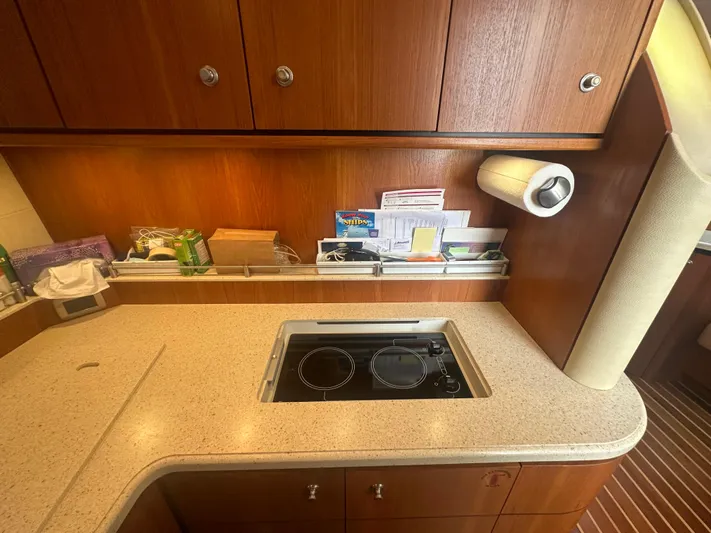 Selladoor (previously "czech Mate") Yacht Photos Pics 2007 Tiara Yachts 4300 Sovran kitchen with stove, wooden cabinets, and countertop.