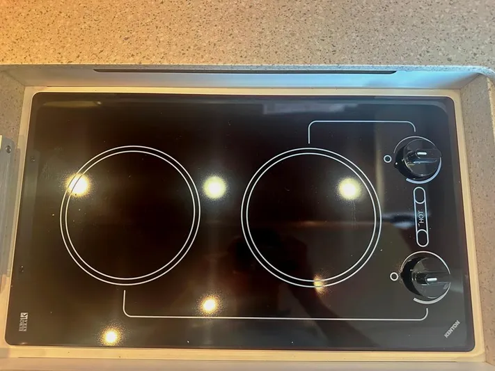 Selladoor (previously "czech Mate") Yacht Photos Pics Electric stovetop on 2007 Tiara Yachts 4300 Sovran, featuring two burners and control knobs.