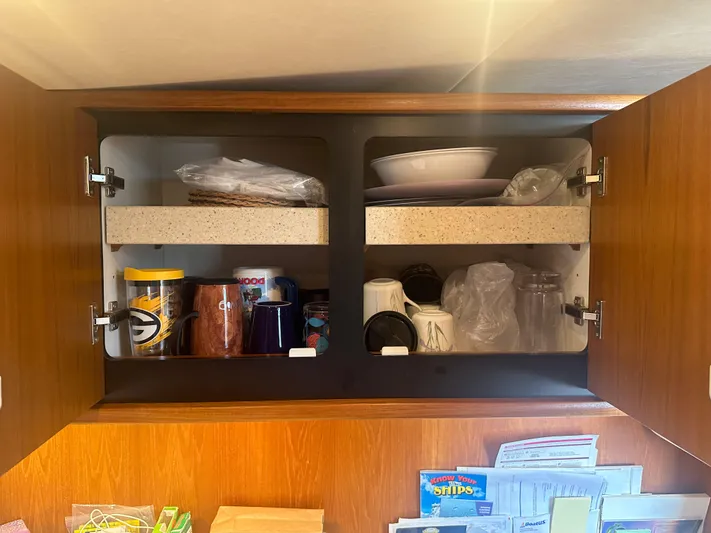 Selladoor (previously "czech Mate") Yacht Photos Pics 2007 Tiara Yachts 4300 Sovran cabinet with mugs, dishes, and kitchen items.