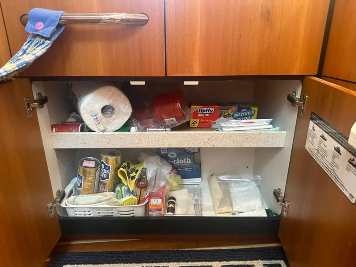 Selladoor (previously "czech Mate") Yacht Photos Pics Storage cabinet on a 2007 Tiara Yachts 4300 Sovran, stocked with household supplies.
