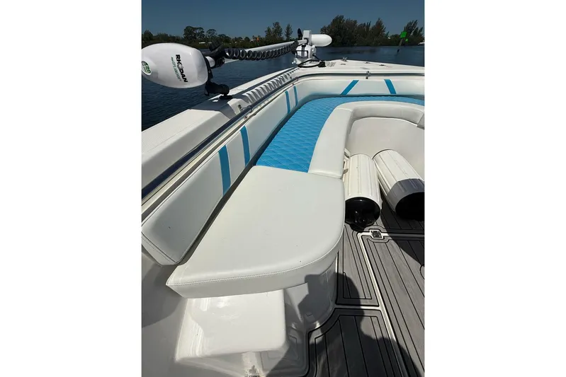  Yacht Photos Pics Custom Infusion 34 CC 2021 boat interior with white and blue seating, docked on water.