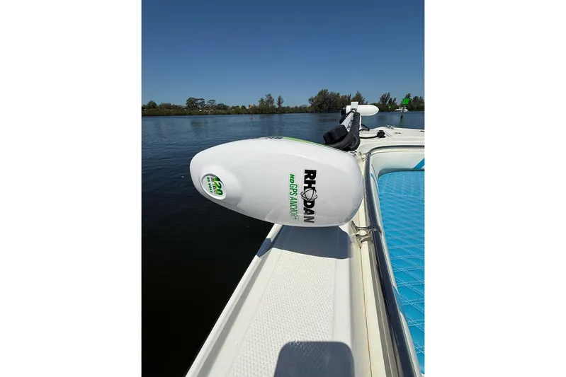  Yacht Photos Pics Custom Infusion 34 CC 2021 boat with Rhodan GPS anchor, blue seating, on calm water.