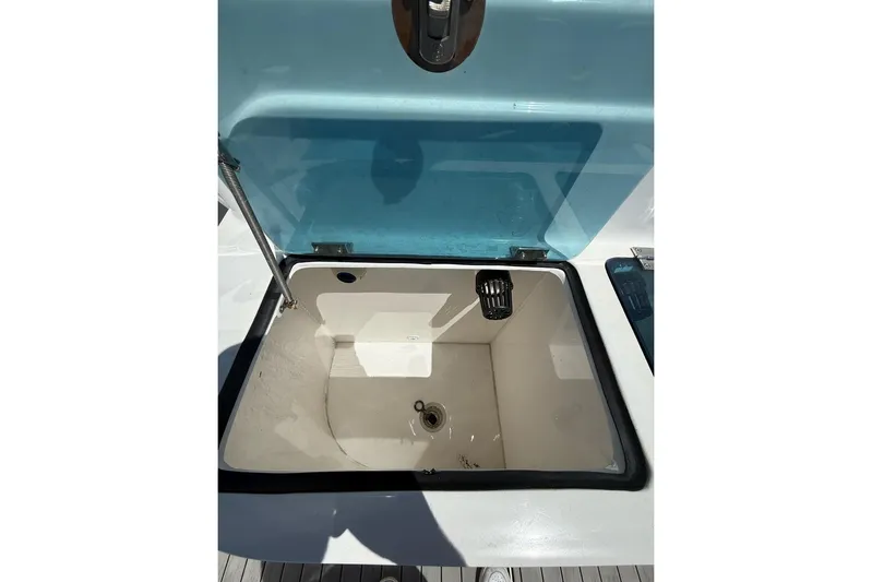  Yacht Photos Pics Open storage compartment on 2021 Custom Infusion 34 CC boat, featuring a blue lid.