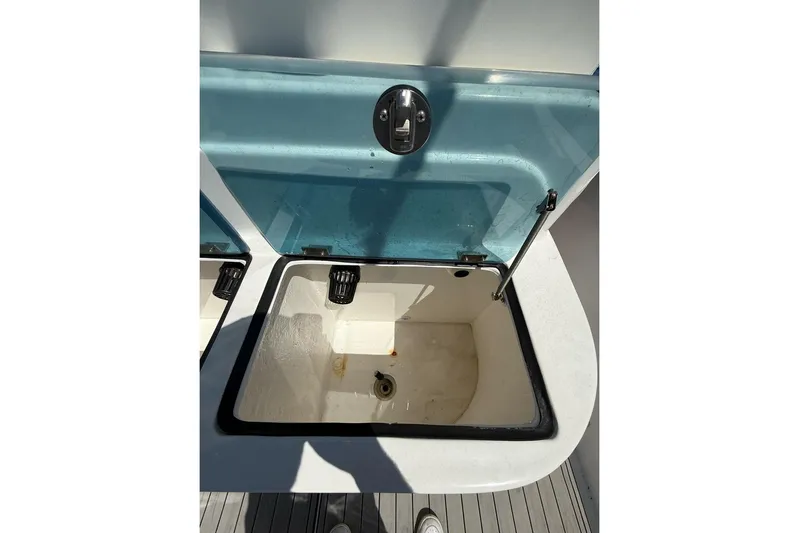  Yacht Photos Pics Open storage compartment on 2021 Custom Infusion 34 CC boat, featuring a blue lid.