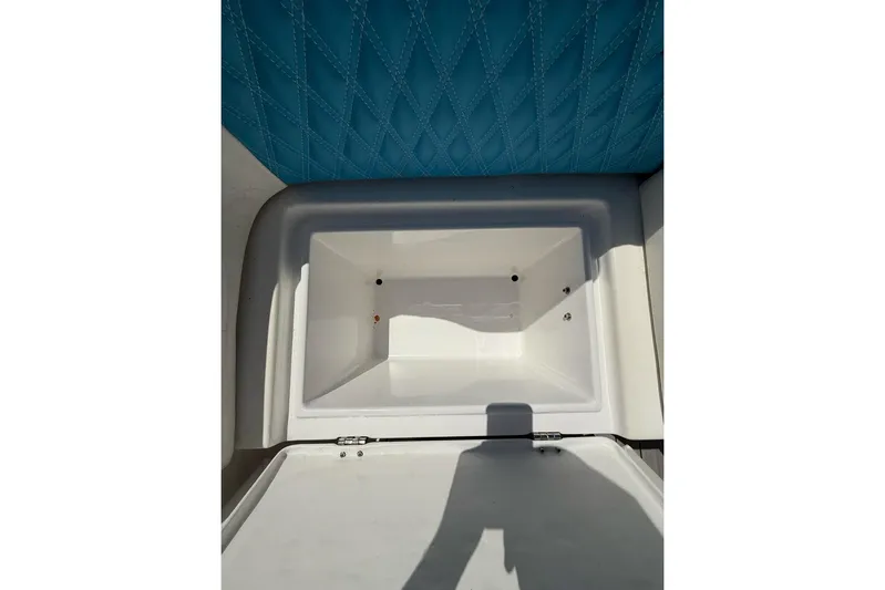  Yacht Photos Pics Open storage compartment on 2021 Custom Infusion 34 CC boat with blue quilted upholstery.