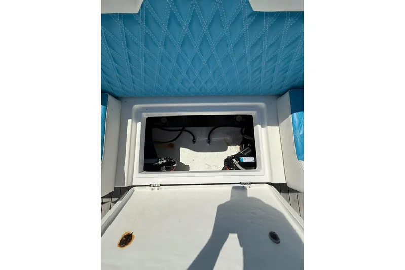  Yacht Photos Pics Open storage compartment on 2021 Custom Infusion 34 CC boat with blue quilted seating.