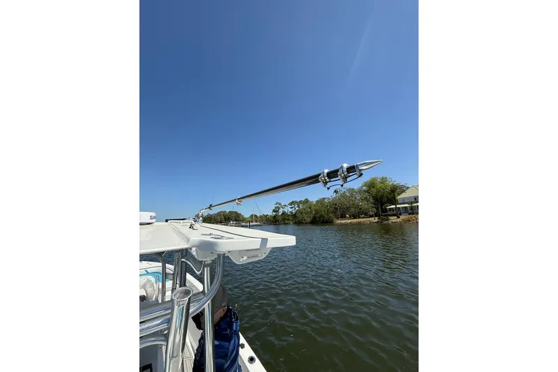  Yacht Photos Pics Custom Infusion 34 CC boat on a sunny day, 2021 model, near a calm riverbank.