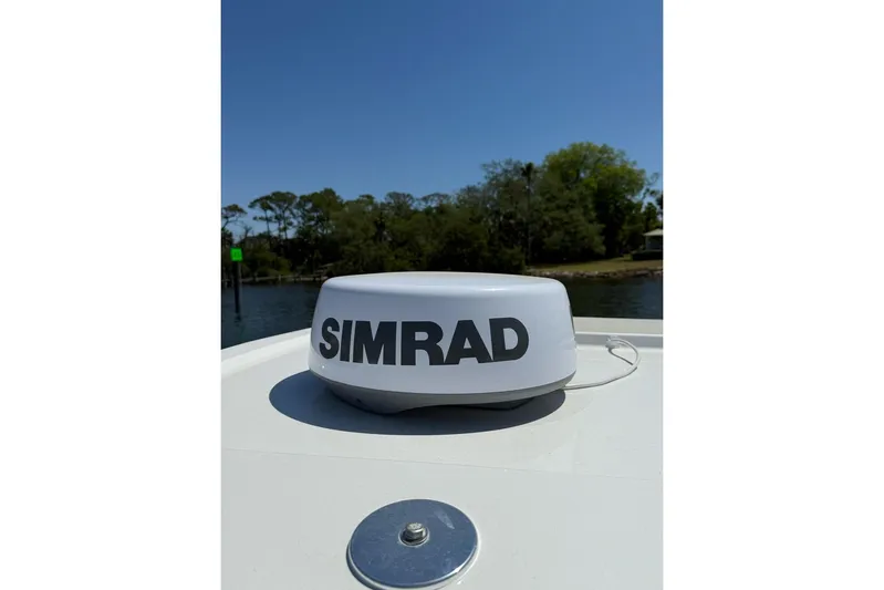  Yacht Photos Pics Simrad radar on 2021 Custom Infusion 34 CC boat, with scenic waterway background.