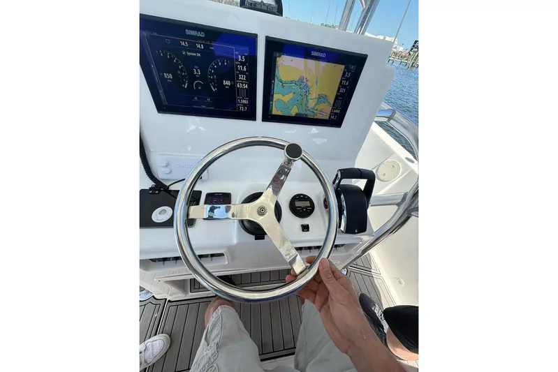 Yacht Photos Pics Steering console of 2021 Custom Infusion 34 CC boat with navigation displays.