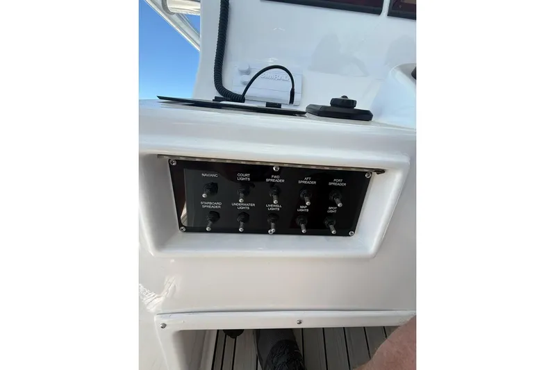  Yacht Photos Pics Control panel on a 2021 Custom Infusion 34 CC boat, featuring various light switches.