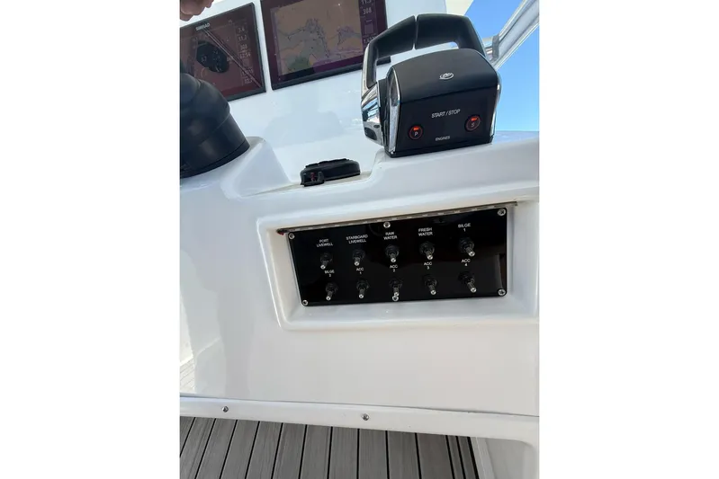  Yacht Photos Pics Control panel of 2021 Custom Infusion 34 CC boat with switches and navigation screens.