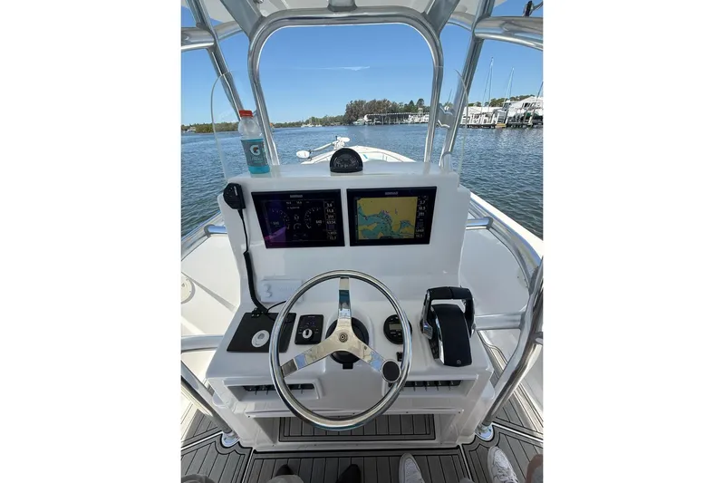  Yacht Photos Pics 2021 Custom Infusion 34 CC boat dashboard with navigation screens and steering wheel.
