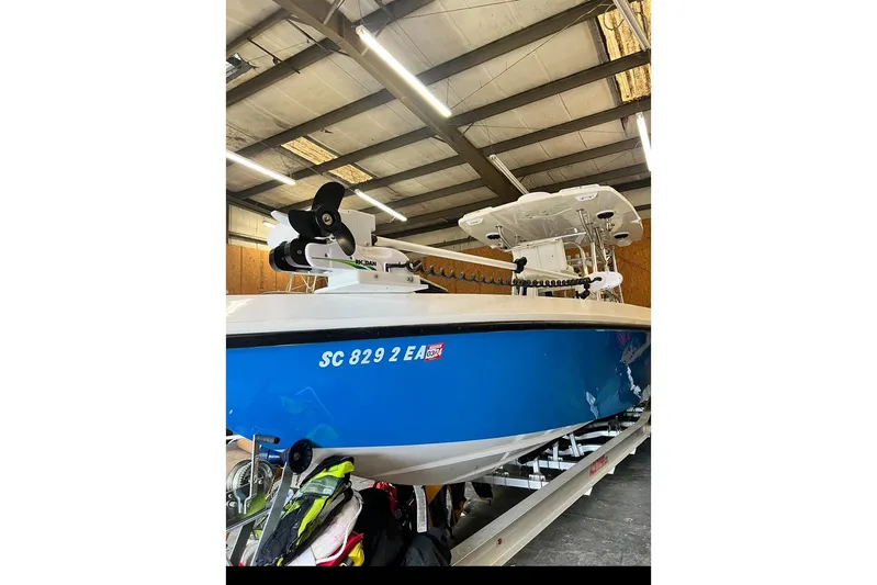  Yacht Photos Pics 2021 Custom Infusion 34 CC boat in a warehouse, blue hull, visible registration number.