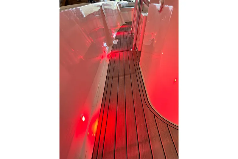 Yacht Photos Pics Custom Infusion 34 CC 2021 boat interior with red LED lighting and wooden flooring.
