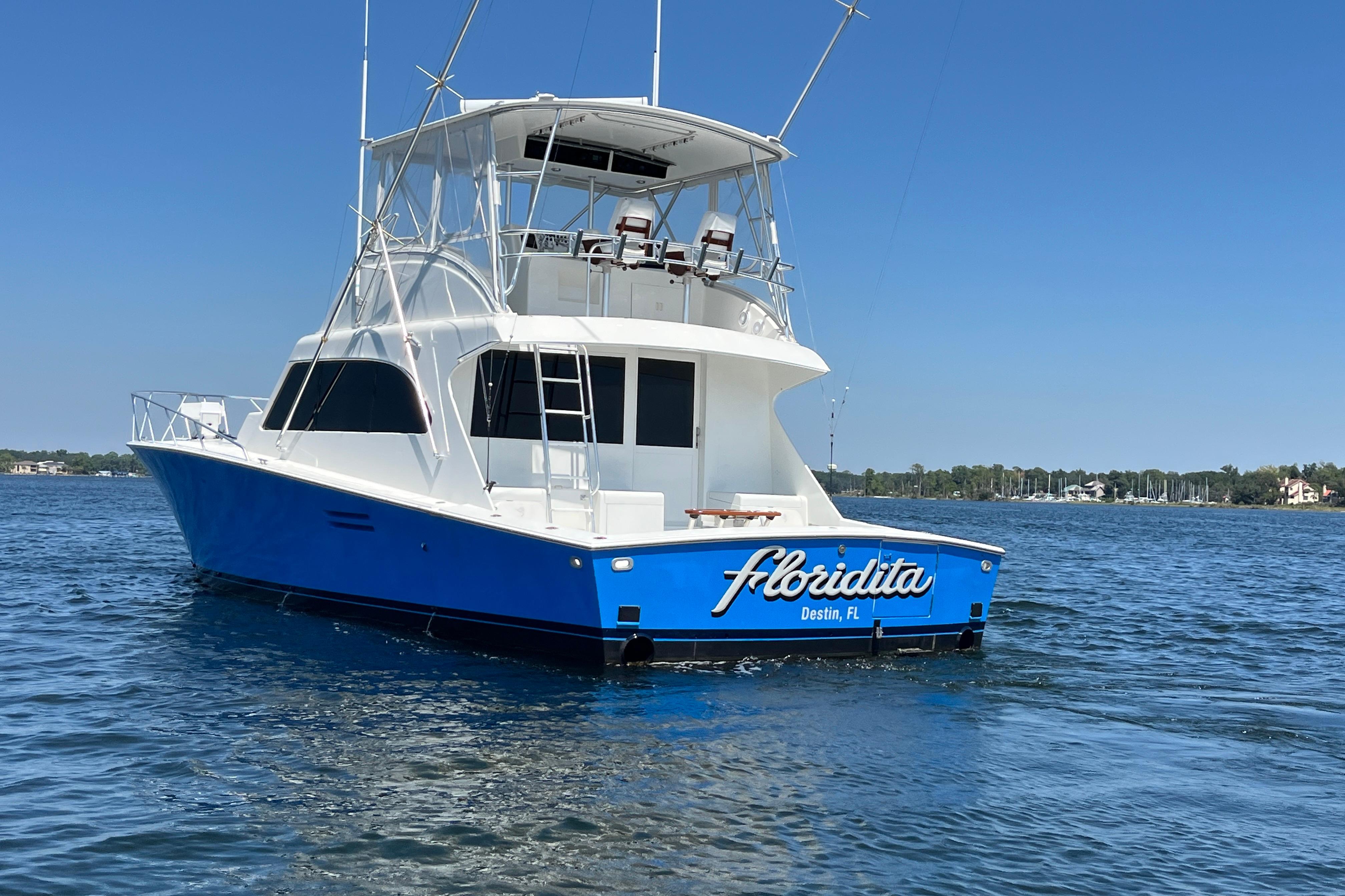 1997 Post Sportfish boat "Floridita" on water, Destin, FL, clear blue sky.