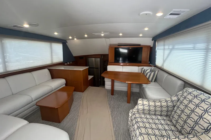 Floridita Yacht Photos Pics Luxurious 1997 Post Sportfish yacht interior with modern seating, table, and TV.