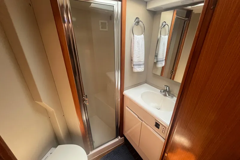 Floridita Yacht Photos Pics Bathroom interior of 1997 Post Sportfish yacht with shower, sink, and mirror.